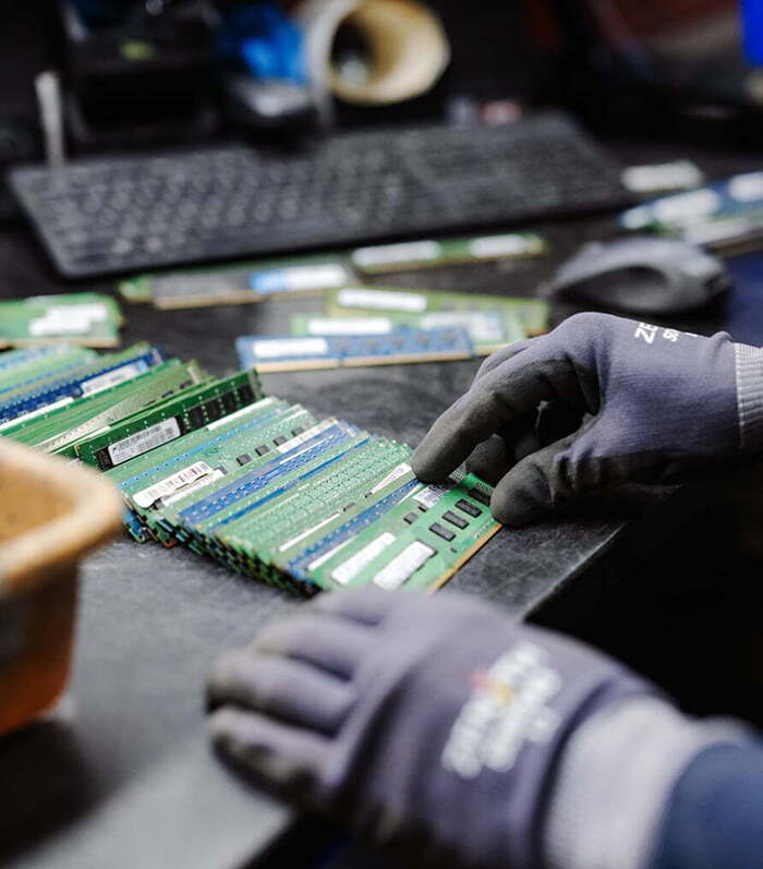 Hands sorting RAM modules in Greentec processing